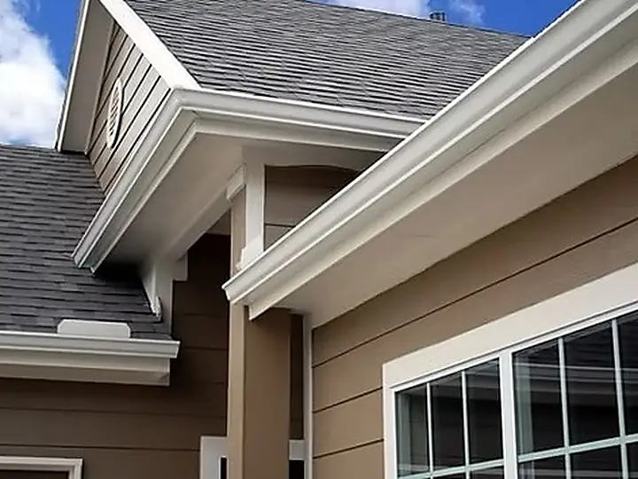 Finished residential roofline with clean white seamless gutters