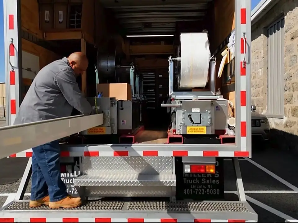 Seamless gutter being fabricated from the back of the Alpha box truck